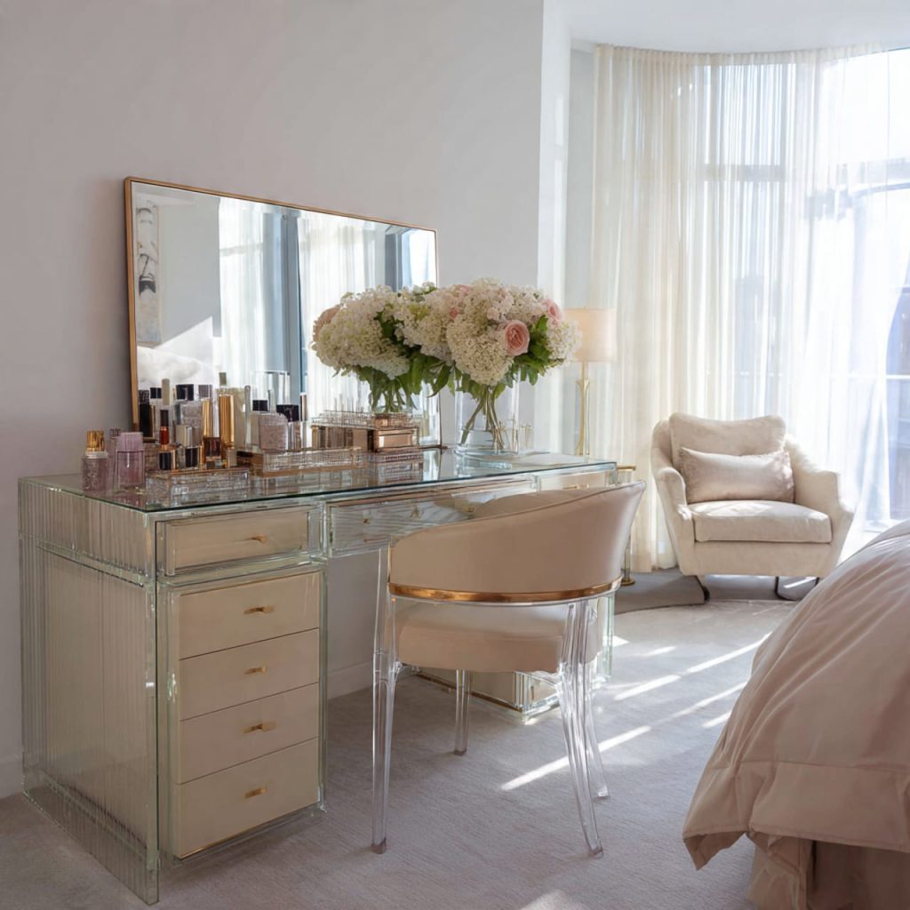 Transparent glass and acrylic vanity in a small bedroom, creating an airy and spacious look with modern luxury finishes