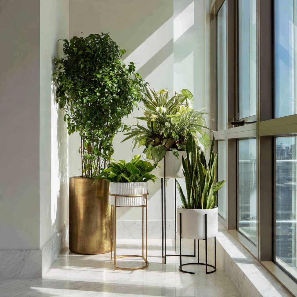 Vertical plant layering creating depth in a modern luxury penthouse interior