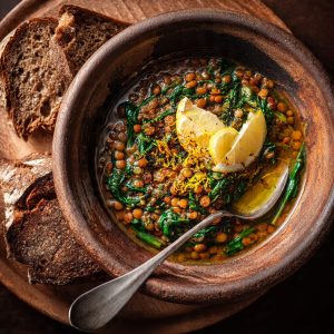 Italian lentil and spinach stew served with olive oil and rustic bread