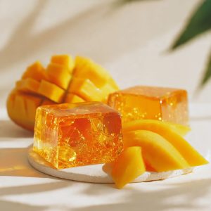 Vegan mango agar jelly with a crystal-clear golden texture, made from ripe mango and agar agar, styled in minimalist plant-based elegance
